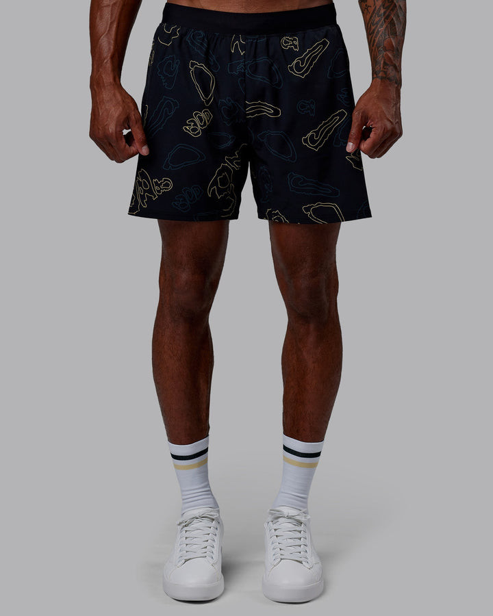 Man wearing Patty Mills Challenger 6&quot; Performance Shorts - Black-Vital Green
