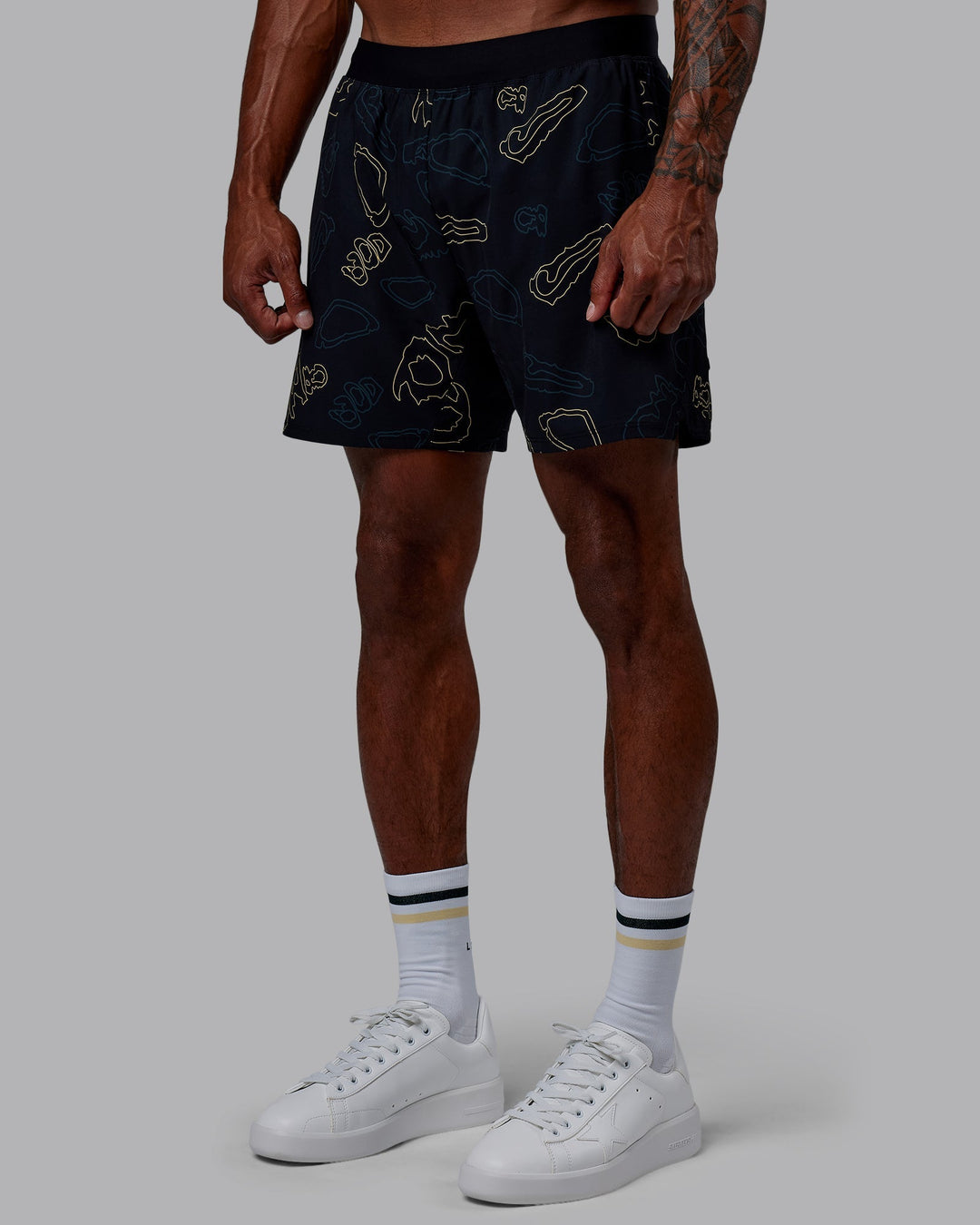 Man wearing Patty Mills Challenger 6&quot; Performance Shorts - Black-Vital Green