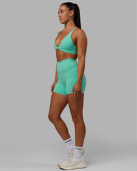 Woman wearing Progression Sports Bra - Aquatic Awe