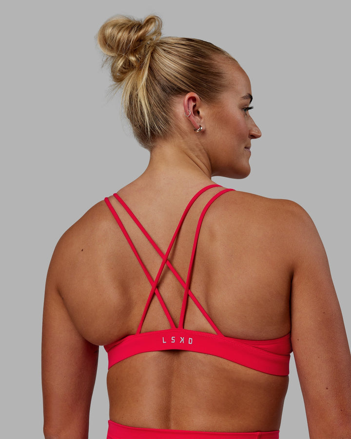 Woman wearing Pursue Sports Bra - Scarlet
