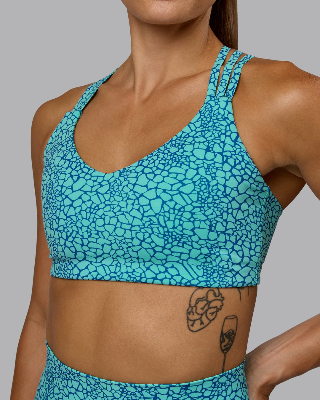 Woman wearing Push The Limit Sports Bra - Aquatic Awe Vitality Print