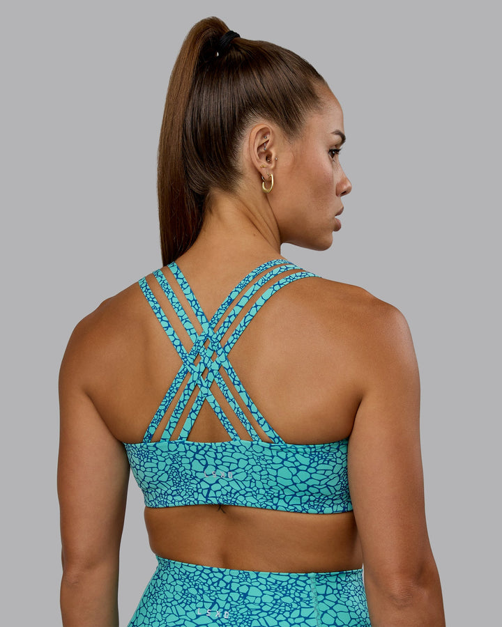 Woman wearing Push The Limit Sports Bra - Aquatic Awe Vitality Print
