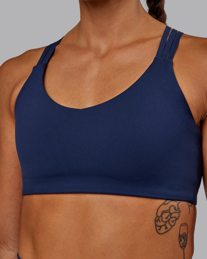 Woman wearing Push The Limit Sports Bra - Future Navy
