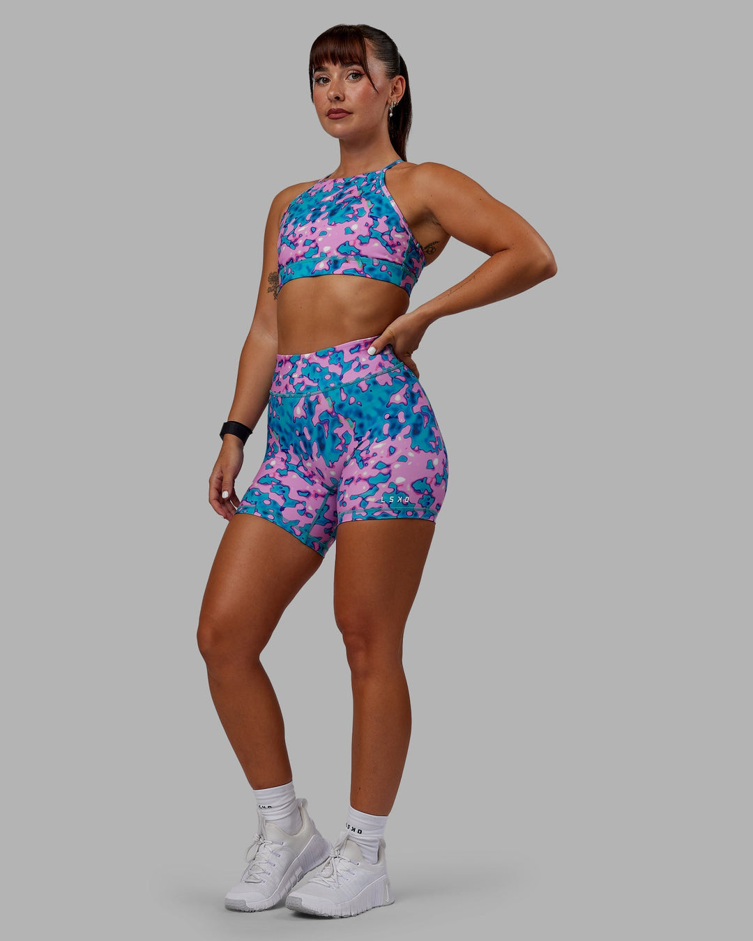 Woman wearing RXD Mid-Length Shorts - Neon Camo