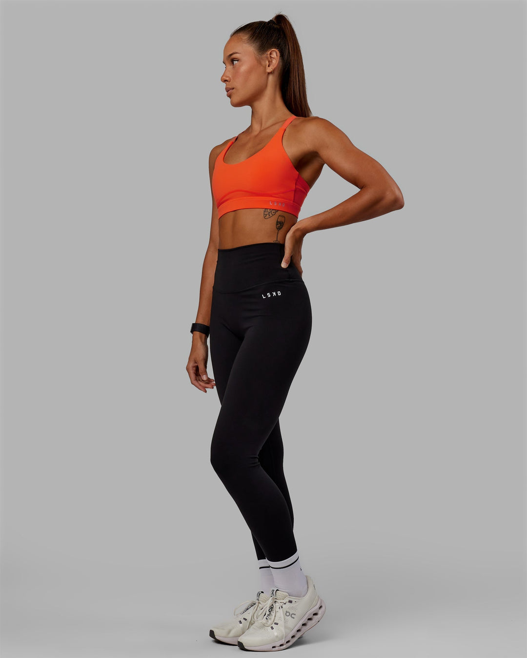 Woman wearing Rapid Sports Bra - Ultra Orange