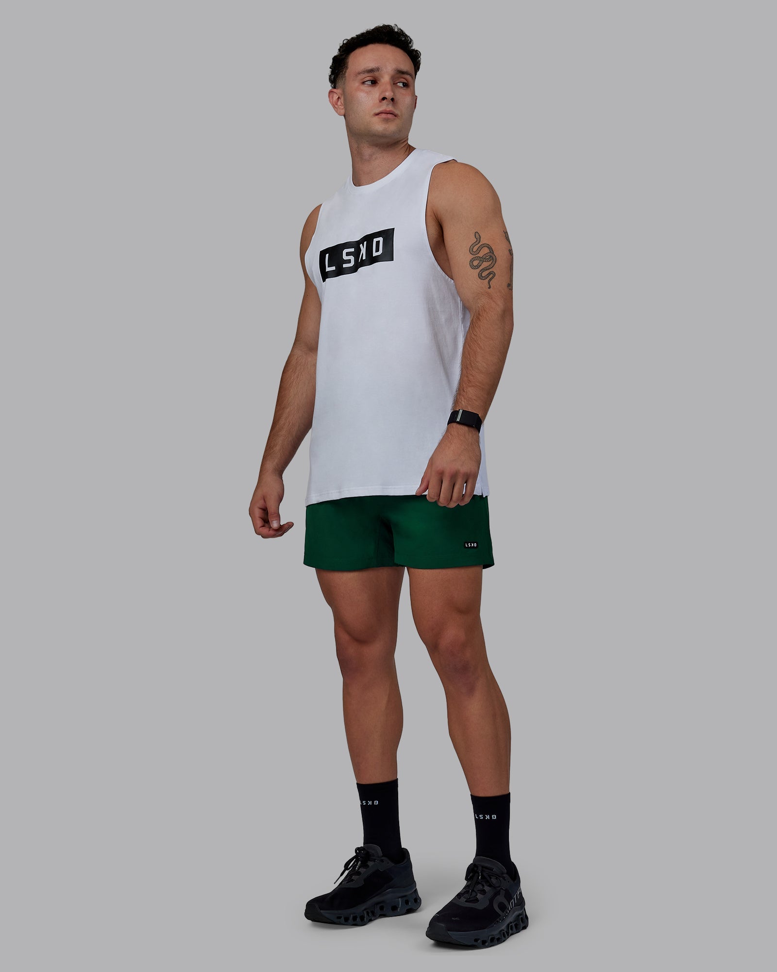 Man wearing Rep 5" Performance Shorts - Deep Emerald