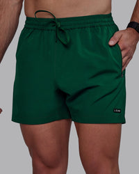 Man wearing Rep 5" Performance Shorts - Deep Emerald