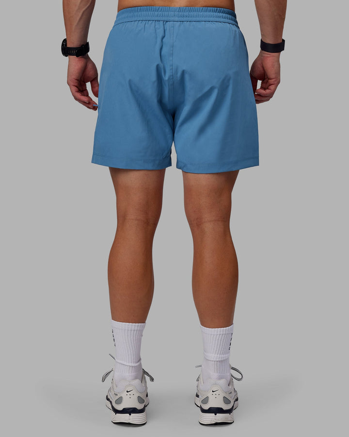 Man wearing Rep 5&quot; Performance Shorts - Elemental Blue
