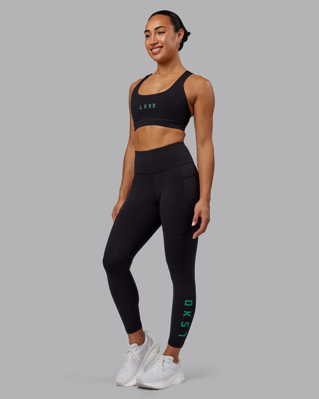 Woman wearing Rep 7/8 Length Leggings - Black-Impact Green