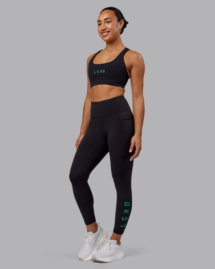 Woman wearing Rep 7/8 Length Leggings - Black-Impact Green
