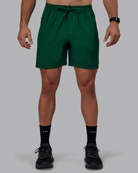 Man wearing Rep 7" Performance Shorts - Deep Emerald