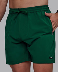 Man wearing Rep 7" Performance Shorts - Deep Emerald