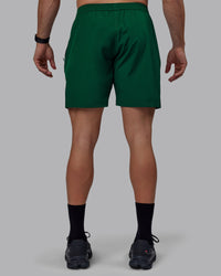 Man wearing Rep 7" Performance Shorts - Deep Emerald