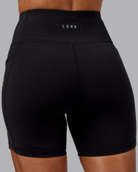 Woman wearing Rep Ultra High-Rise 6" Short Pockets - Black-Scarlet