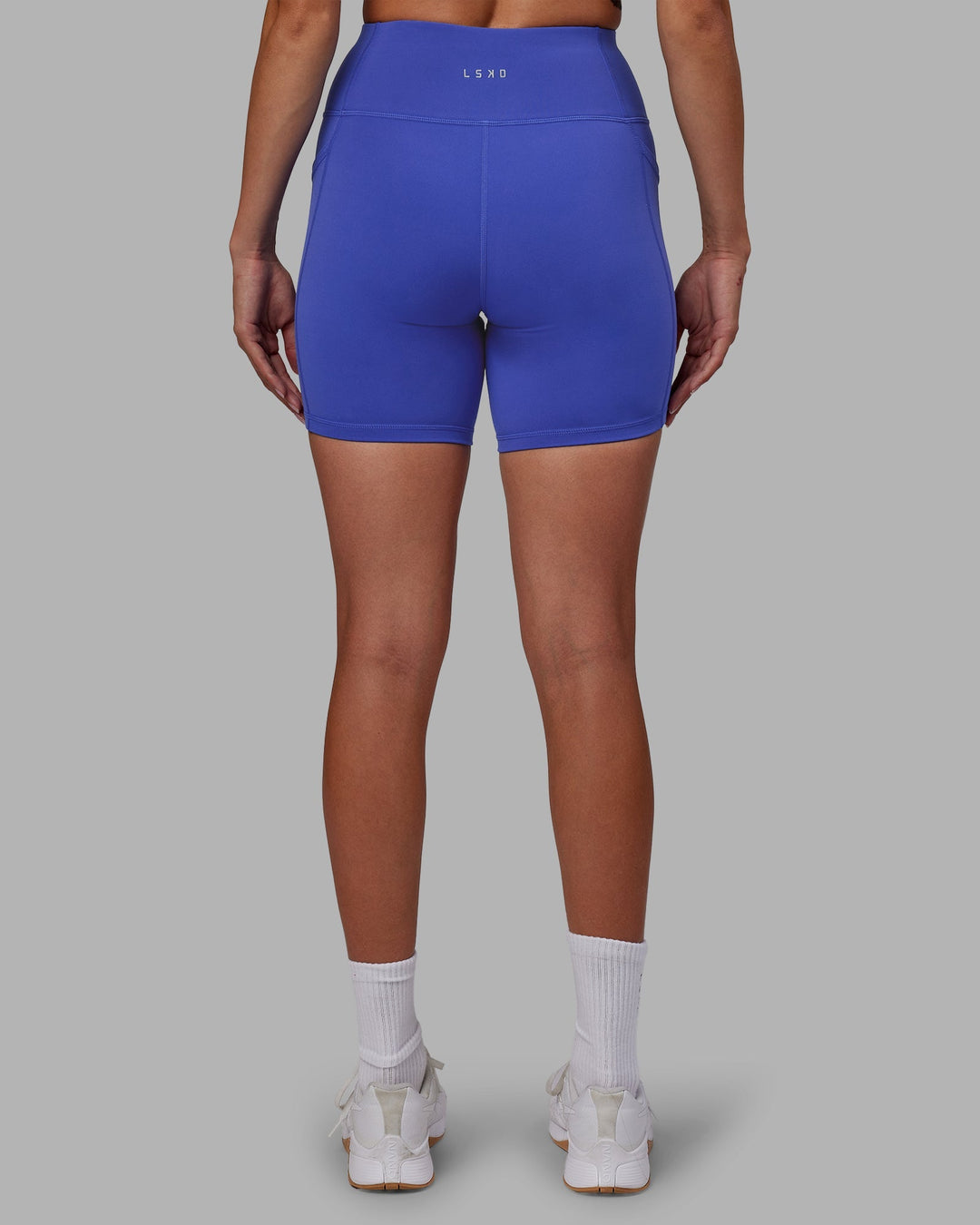 Woman wearing Rep Mid-Length Shorts - Power Cobalt-White