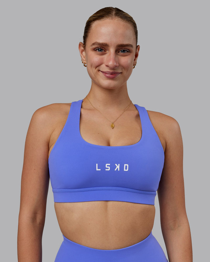 Woman wearing Rep Sports Bra - Baja Blue-White
