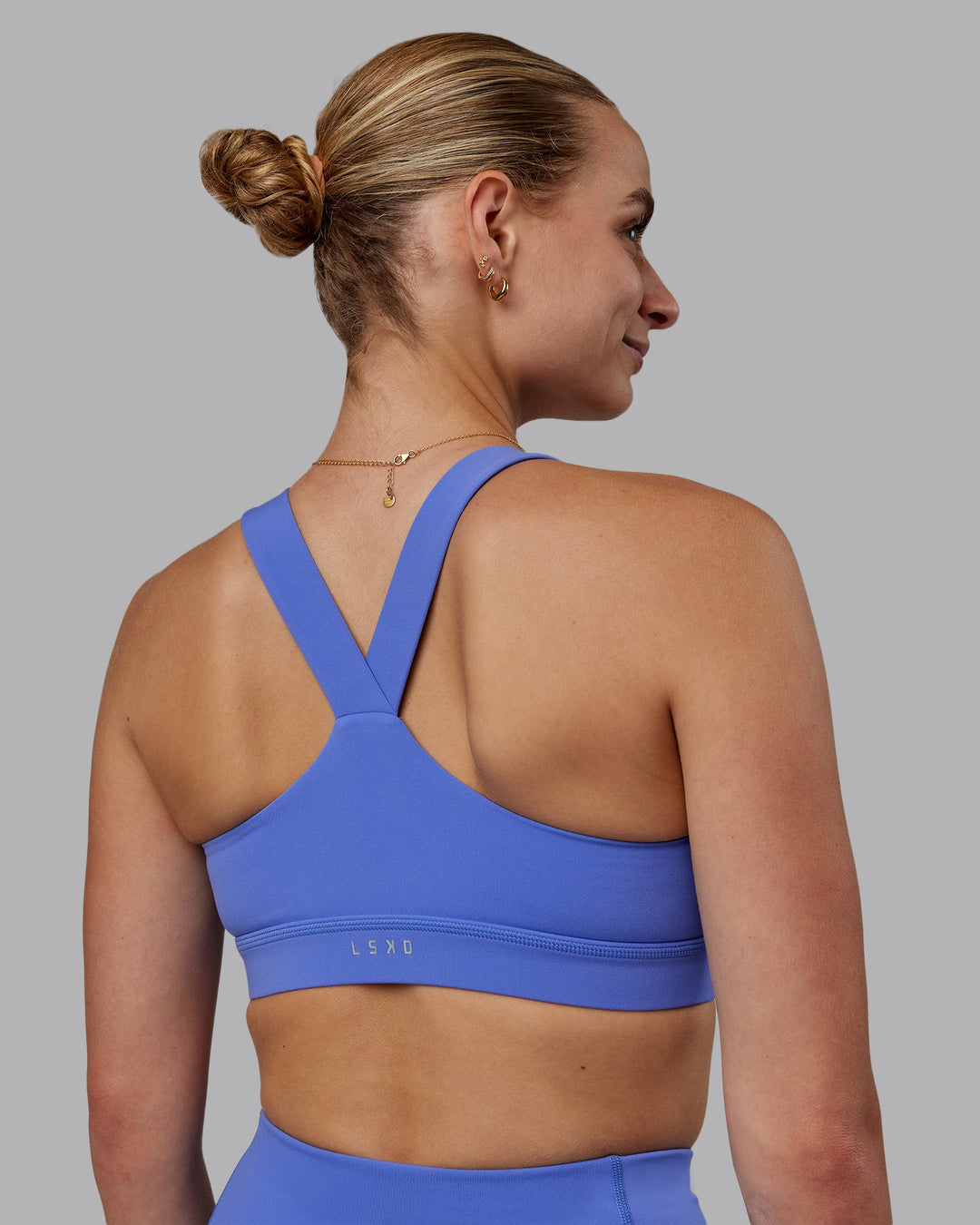 Woman wearing Rep Sports Bra - Baja Blue-White