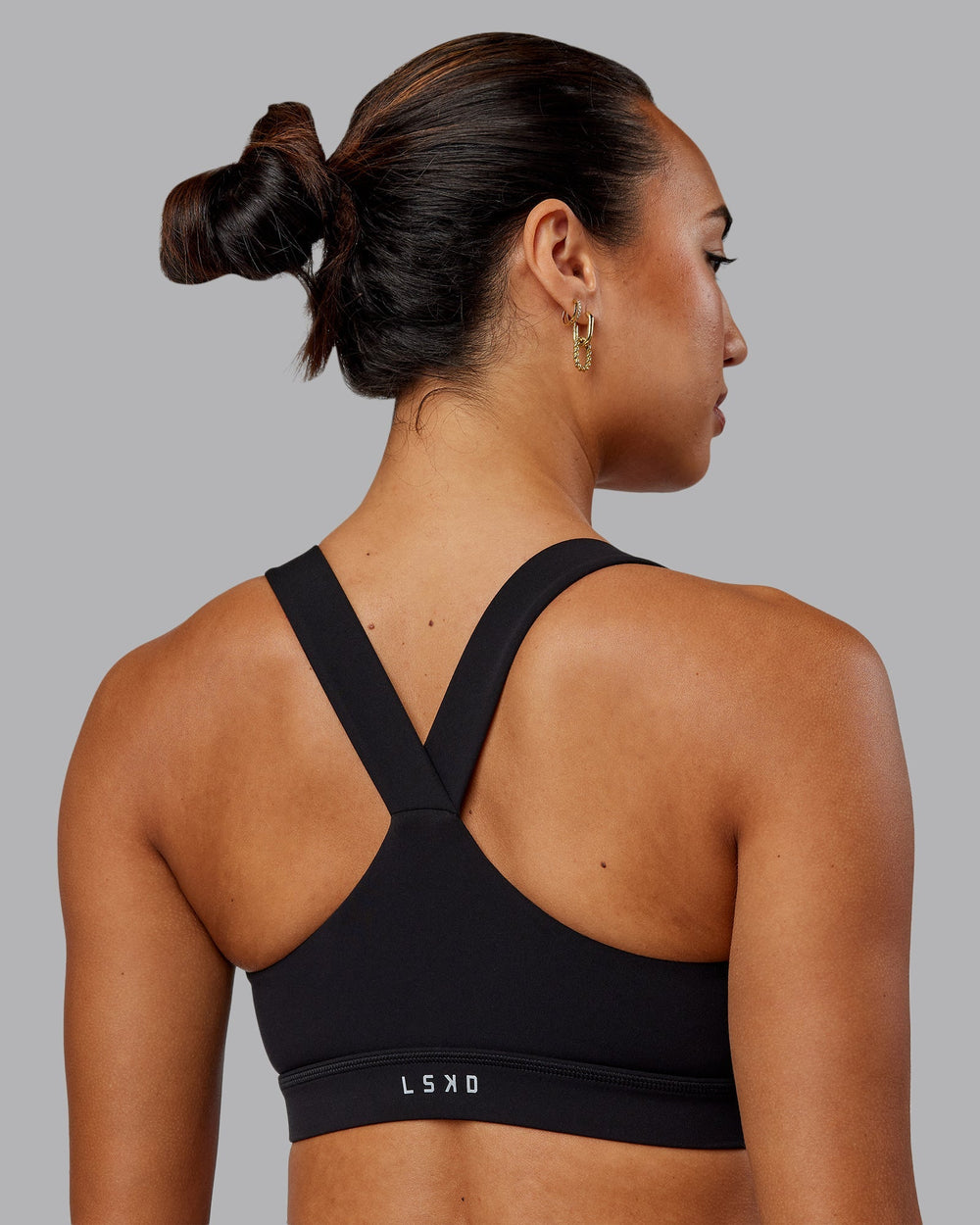 Woman wearing Rep Sports Bra - Black-Impact Green