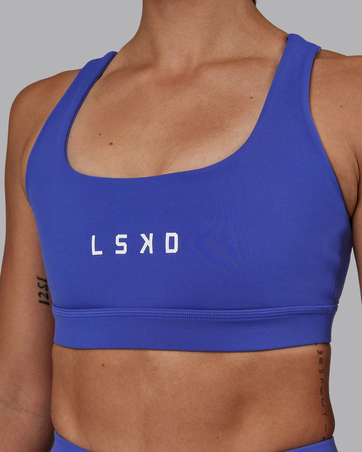 Woman wearing Rep Sports Bra - Power Cobalt-White
