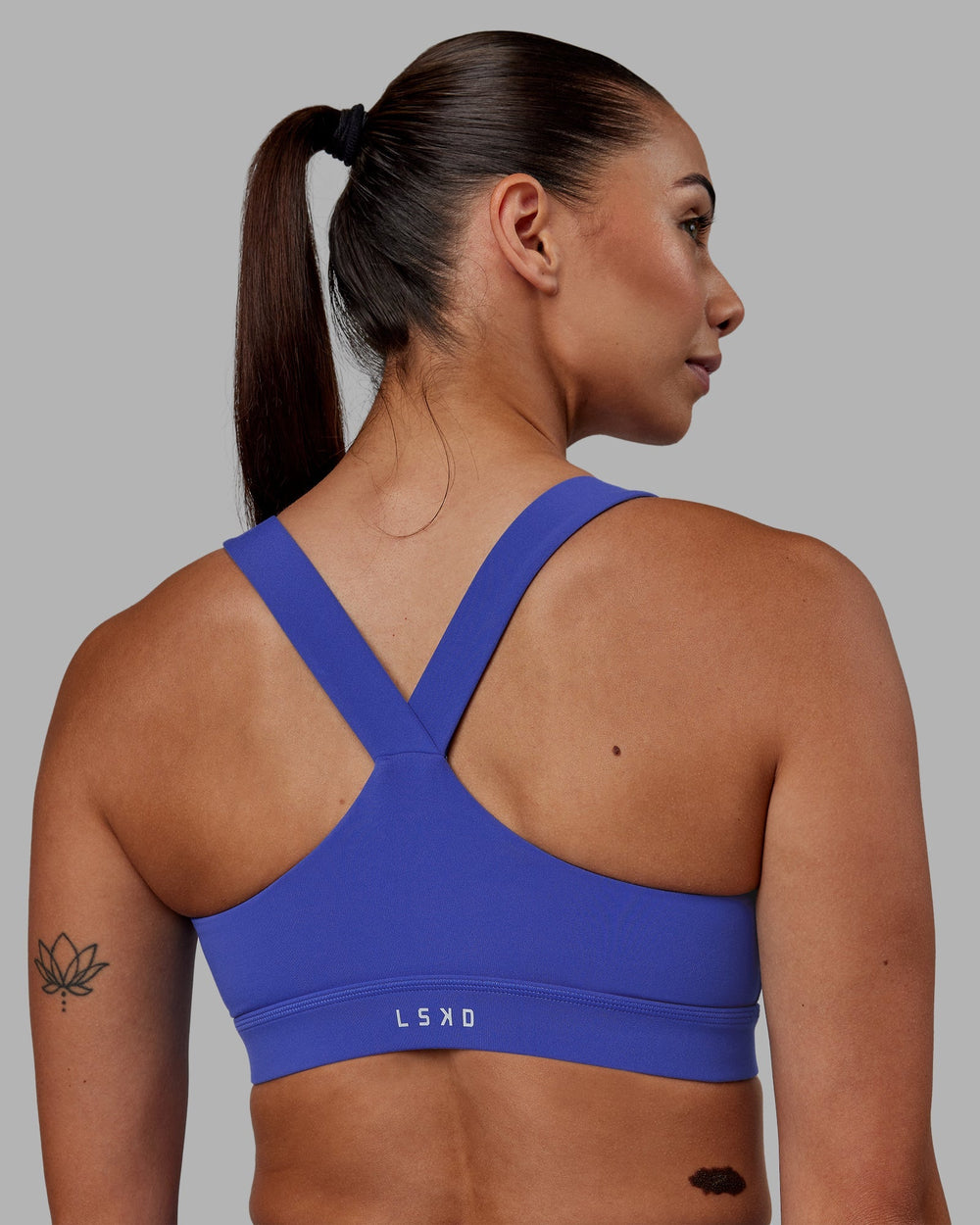 Woman wearing Rep Sports Bra - Power Cobalt-White