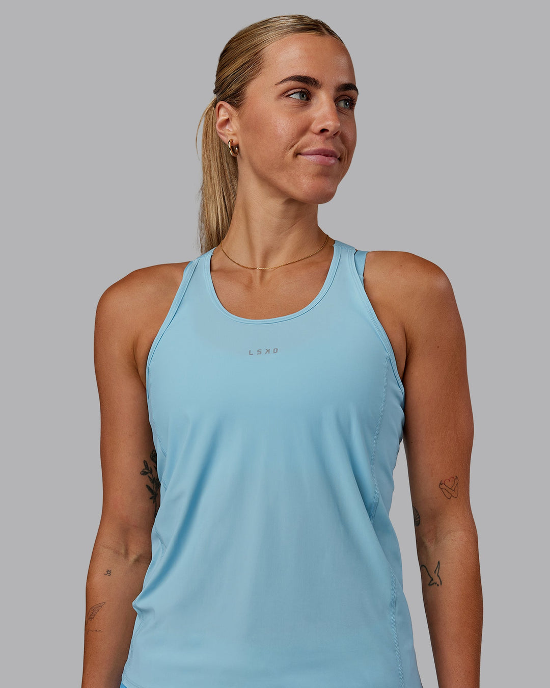 Woman wearing Rush Performance Tank - Sky Blue