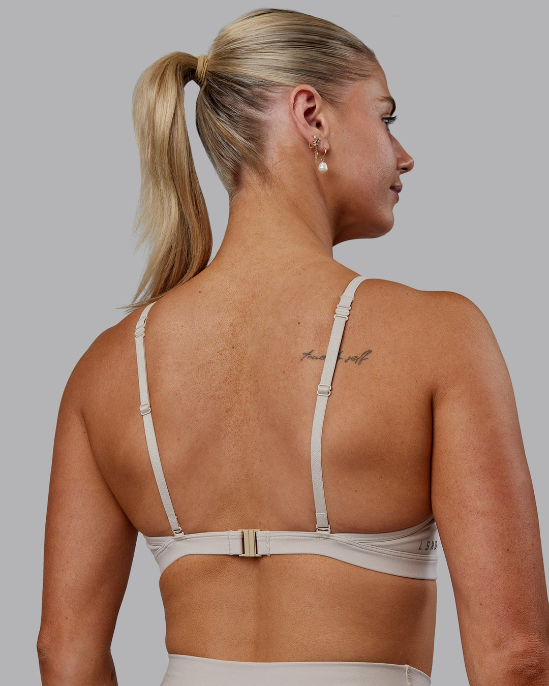 Woman wearing Sara Ares High Neck Sports Bra - Shale Beige