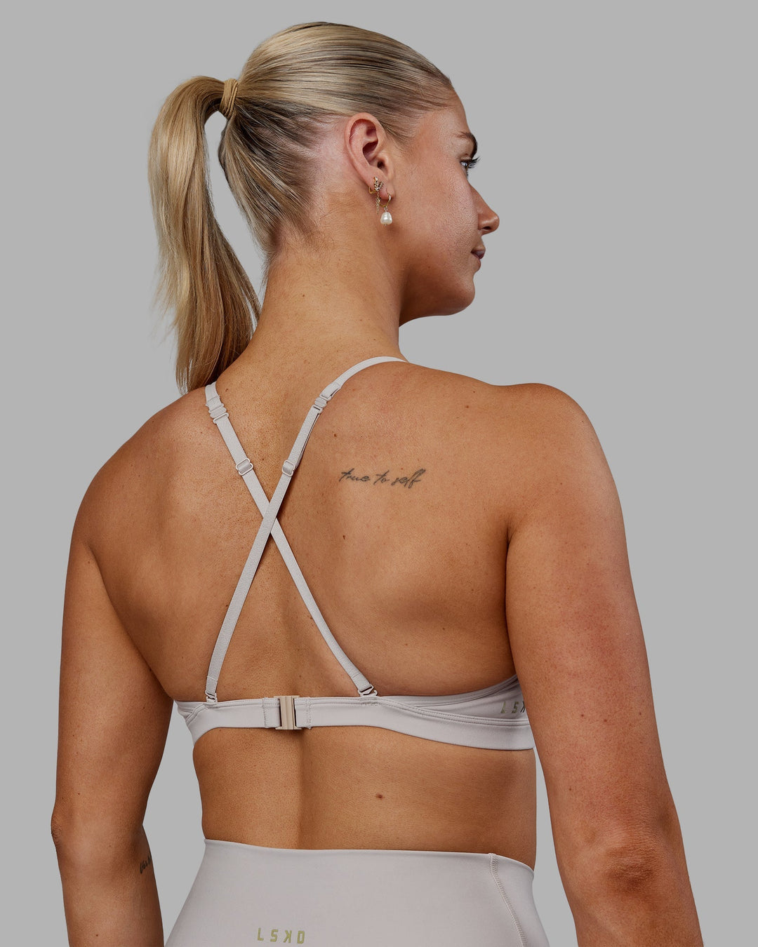 Woman wearing Sara Ares High Neck Sports Bra - Shale Beige