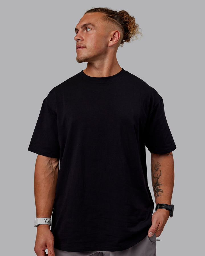 Man wearing Sara GET ÆTLA SKAL Unisex FLXCotton Oversize Tee - Black-White
