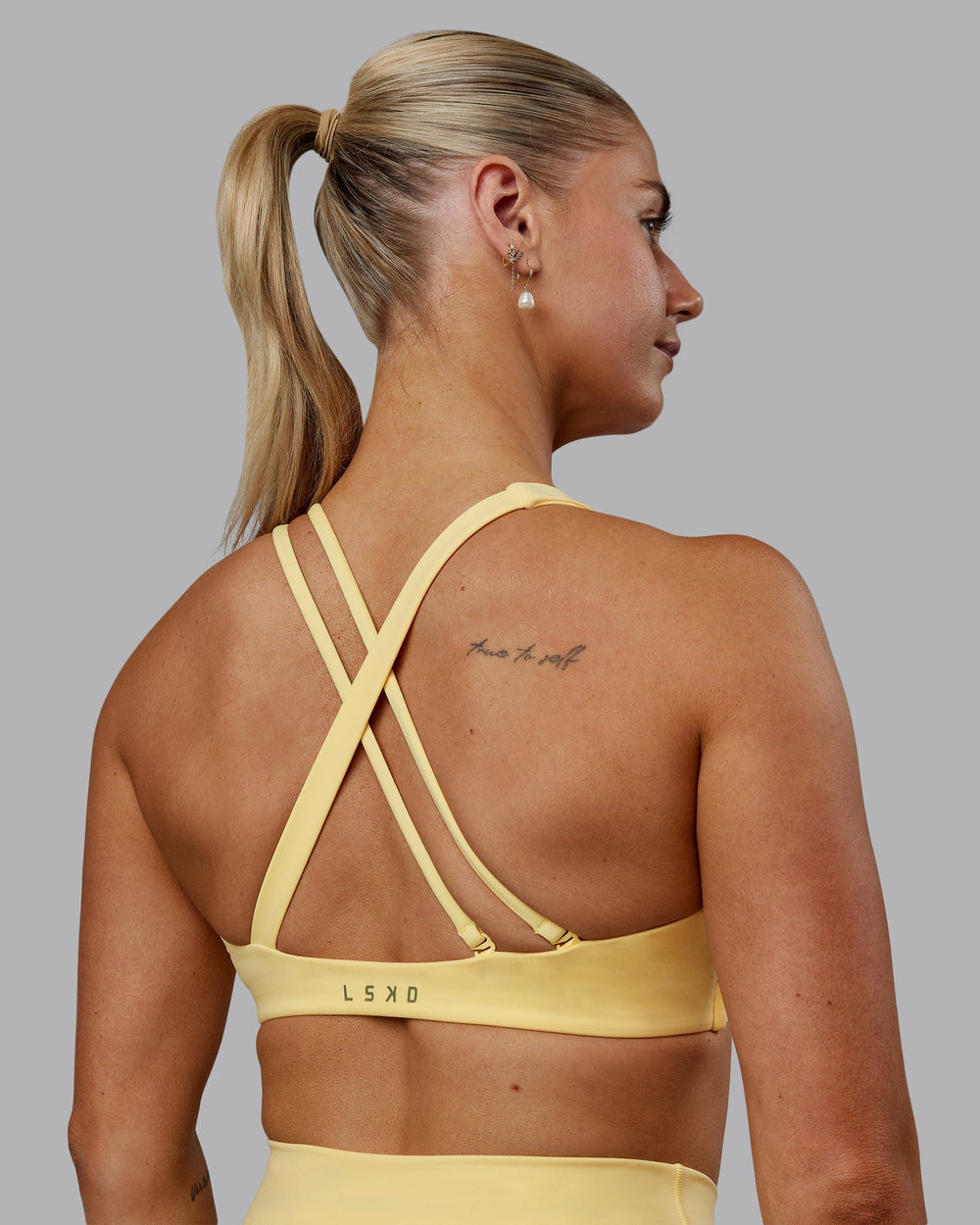 Woman wearing Sara Helios Sports Bra - Sunflower