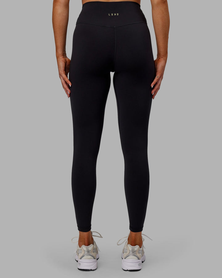 Woman wearing Sara Strike Cross Over Waist Full Length Leggings - Black
