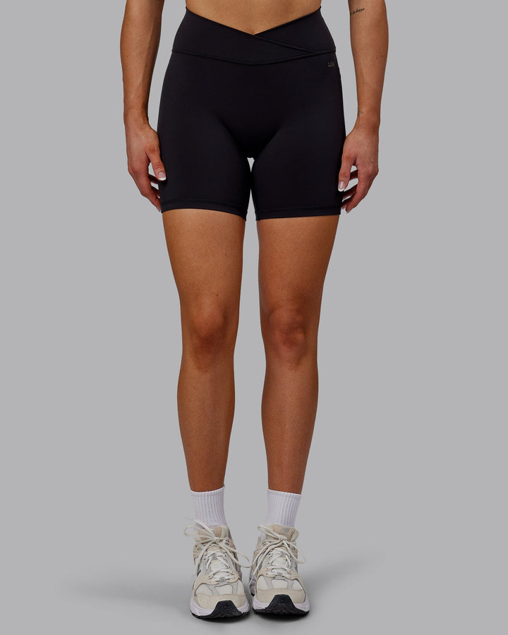 Woman wearing Sara Strike Cross Over Waist Mid-Length Shorts - Black
