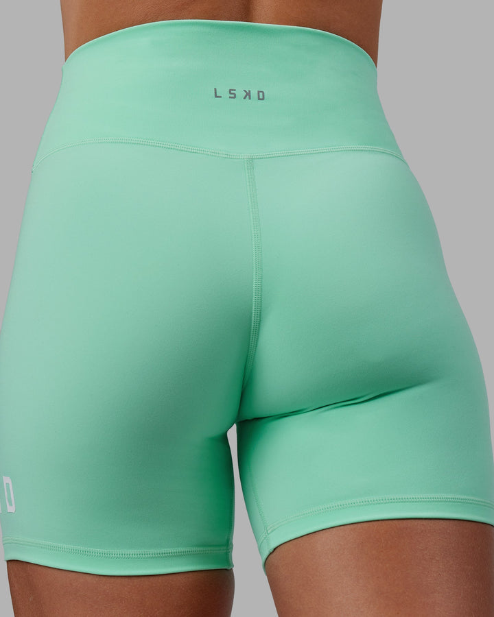 Woman wearing Shayna Jack X LSKD Evolved Mid-Length Shorts - Ice Green-White
