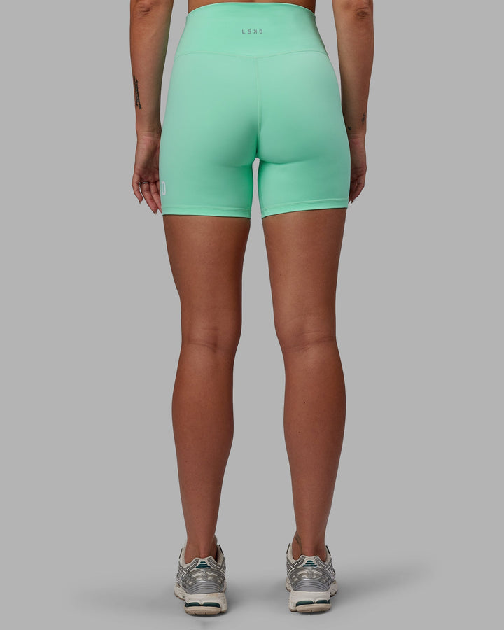 Woman wearing Shayna Jack X LSKD Evolved Mid-Length Shorts - Ice Green-White
