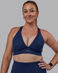 Woman wearing Stamina Sports Bra (D/DD/E) - Future Navy | Model:Tegan | Size:M