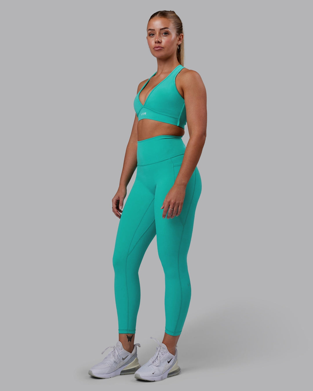 Woman wearing Stamina Sports Bra - Turquoise Tide