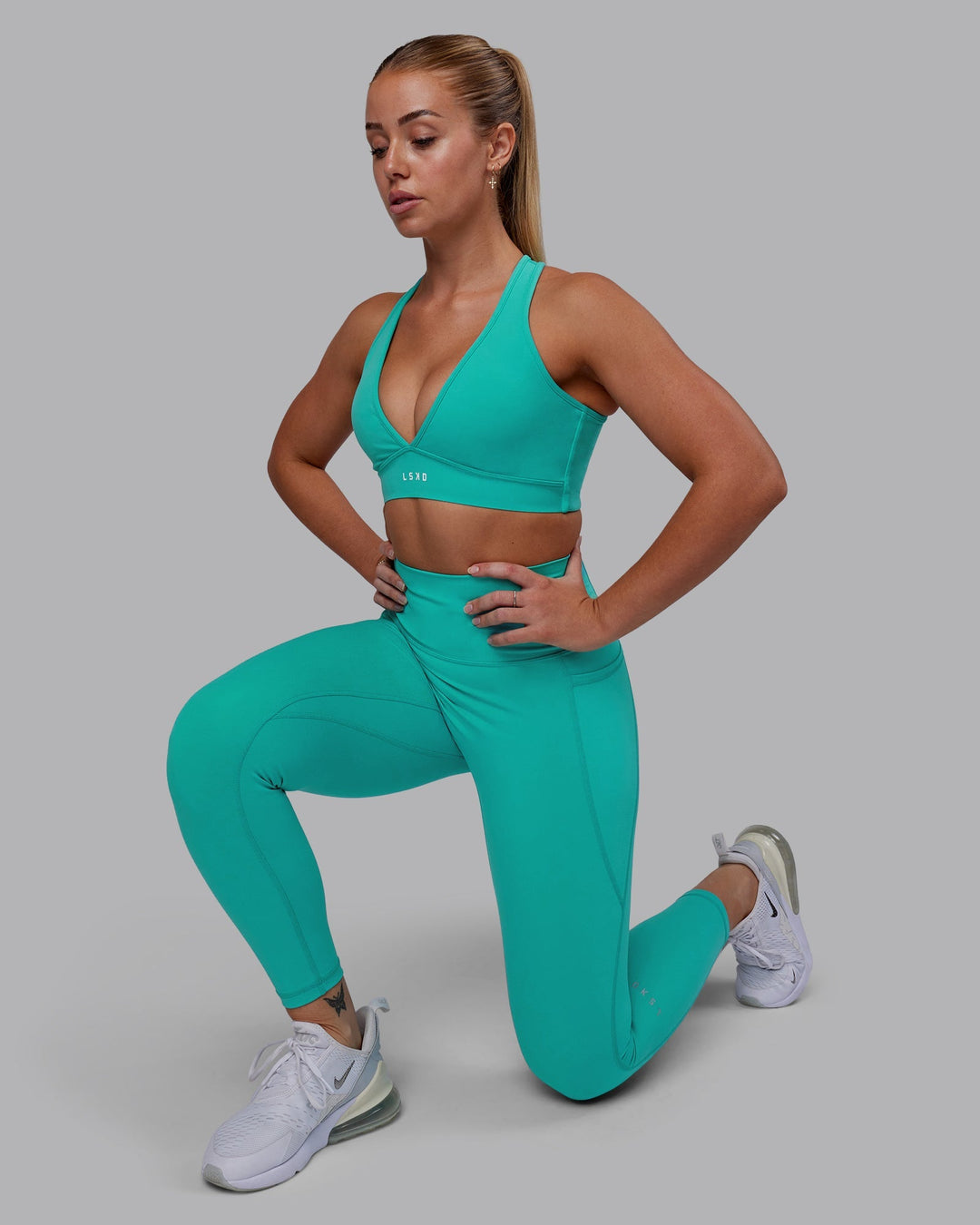 Woman wearing Stamina Sports Bra - Turquoise Tide