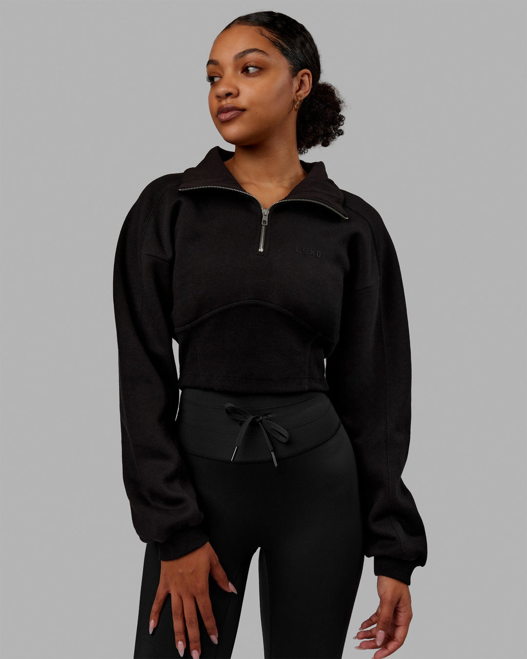 Woman wearing Thrive Corset 1/4 Zip Sweater - Black