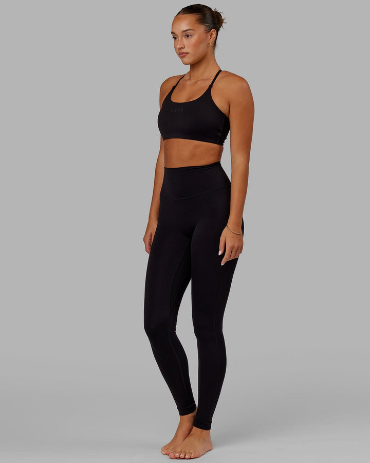 Woman wearing Twist Sports Bra - Black
