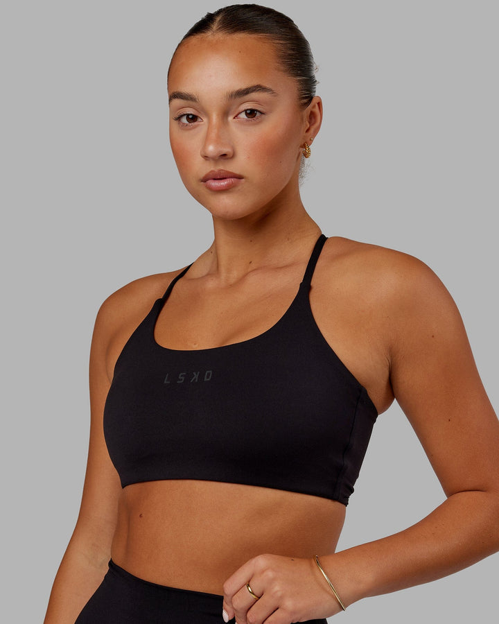 Woman wearing Twist Sports Bra - Black
