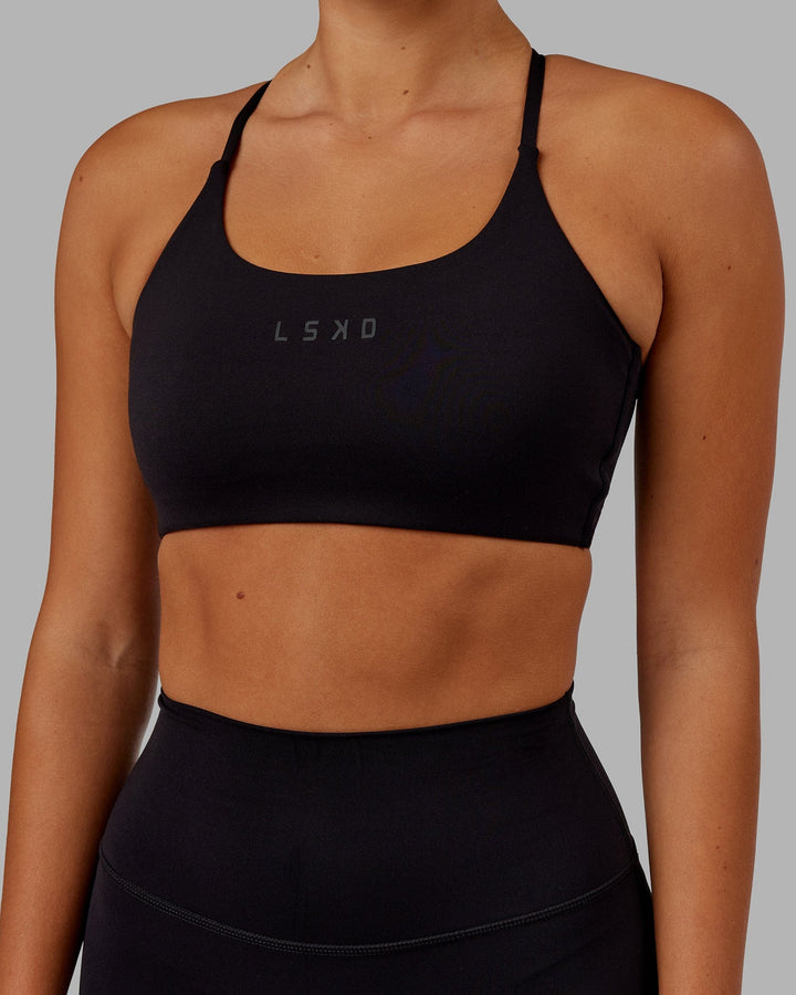 Woman wearing Twist Sports Bra - Black
