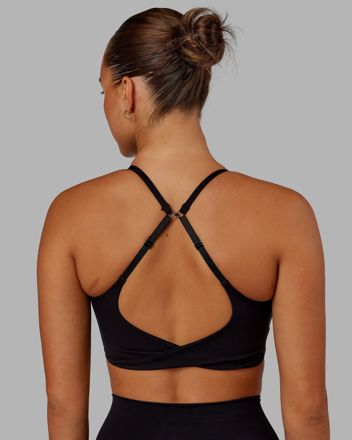 Woman wearing Twist Sports Bra - Black