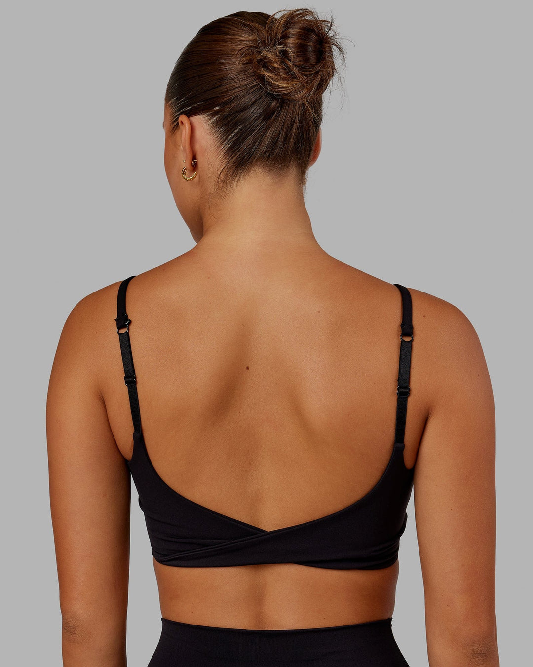 Woman wearing Twist Sports Bra - Black