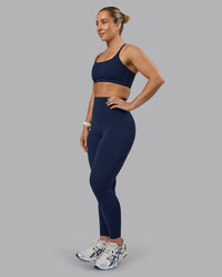 Woman wearing Twist Sports Bra - Future Navy | Model:Lyss | Size:S