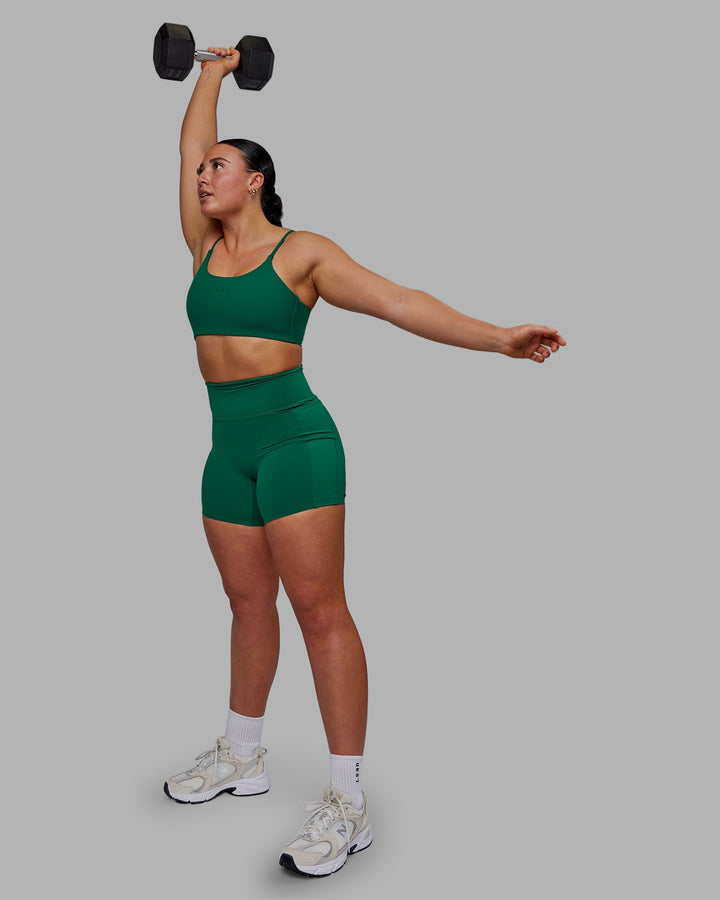 Woman wearing Twist Sports Bra - Malachite
