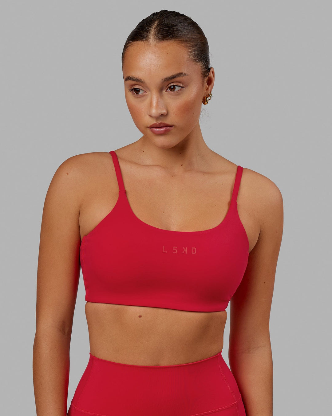 Woman wearing Twist Sports Bra - Scarlet