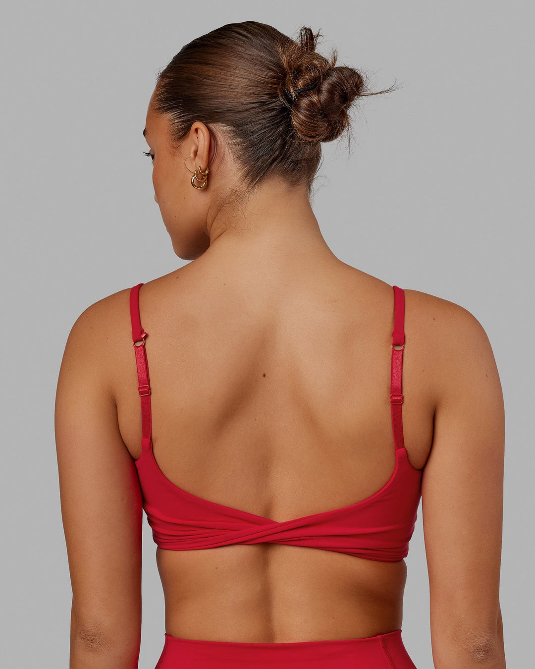 Woman wearing Twist Sports Bra - Scarlet