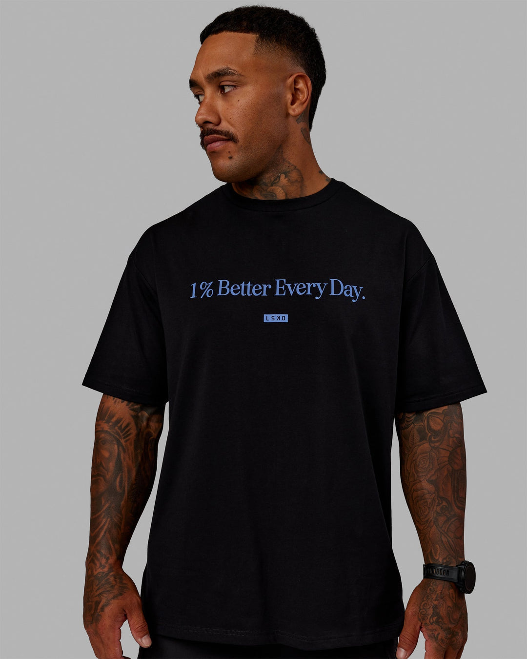 Man wearing Unisex 1% Better FLXCotton Tee Oversize - Black-Power Cobalt