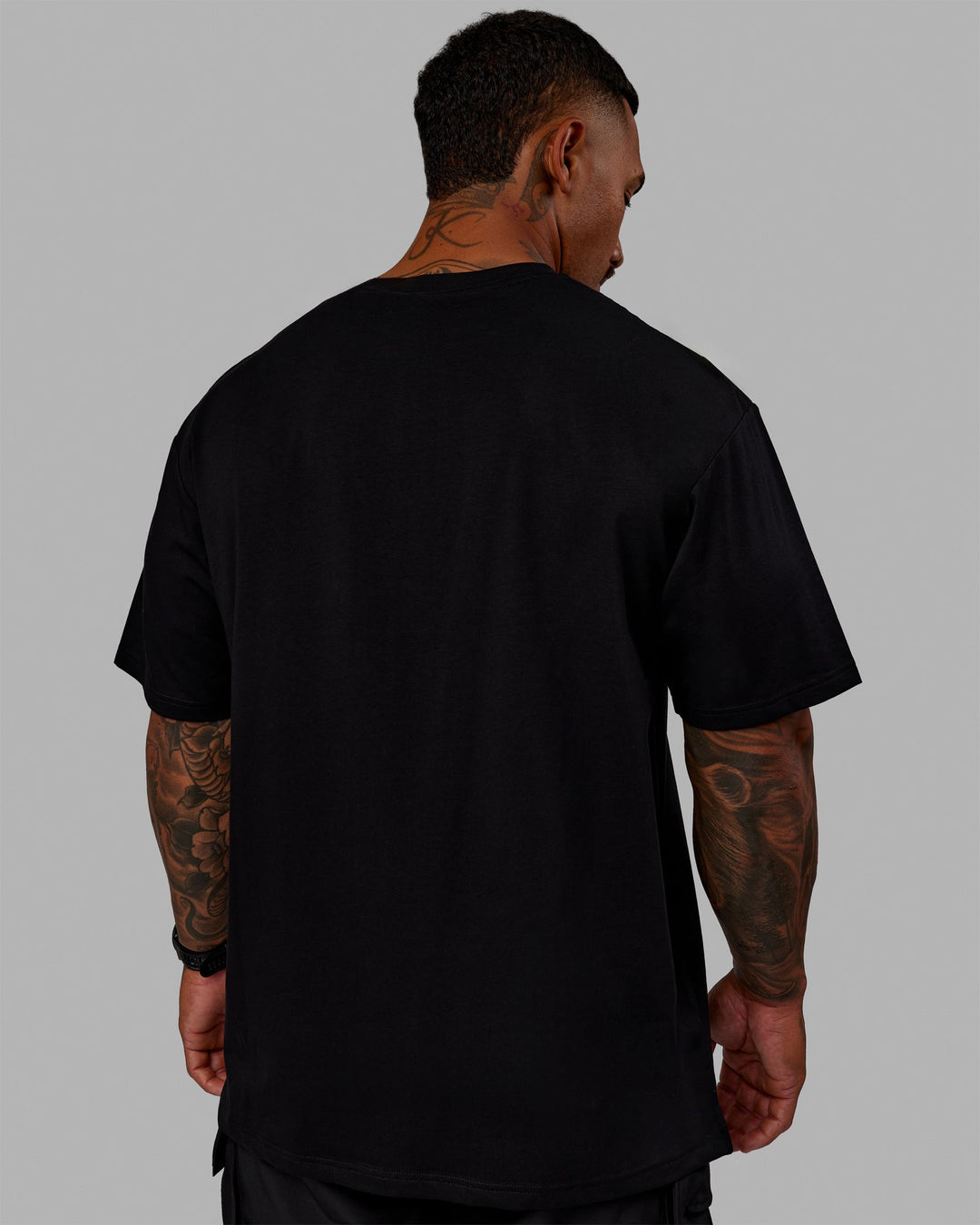 Man wearing Unisex 1% Better FLXCotton Tee Oversize - Black-Power Cobalt