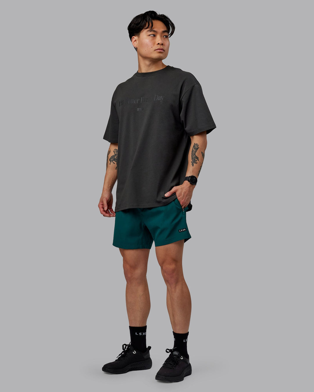 Man wearing Unisex 1% Better FLXCotton Tee Oversize - Pirate Black-Black