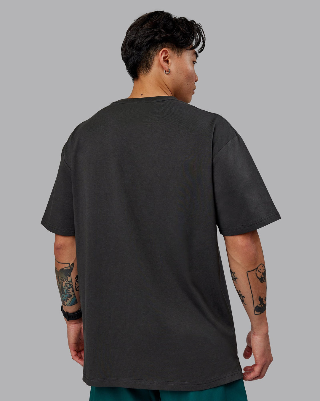 Man wearing Unisex 1% Better FLXCotton Tee Oversize - Pirate Black-Black